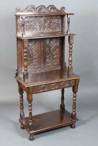 A late 17th Century style oak buffet, 19th Century and later, the upper section with foliate carved back fitted 2 shelves above a  potboard, raised on turned supports and feet 56"h x 27"w x 13"d