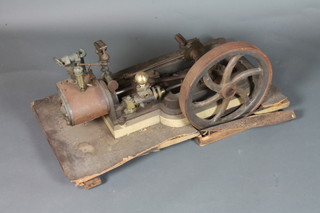 A stationery steam engine with 6 spoked fly wheel, raised on a rectangular board 28"
