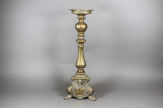 A Rococo style brass candlestick, raised on 3 hoof supports 20"
