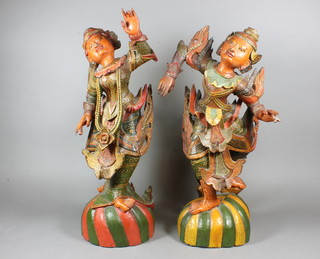 A pair of late 19th Century Balinese carved and painted figures of standing dancers 20"