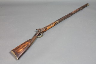 A percussion cap fowling piece, the 31" barrel marked London  with walnut stock, complete with ram rod
