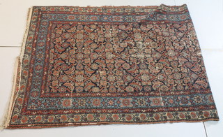 A North Western Persian blue ground carpet with all-over  geometric design within a multi-row border 158" x 66"