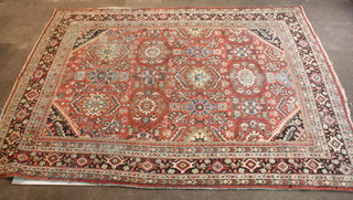 A North West Persian red ground carpet with stylised gulls to  the centre within multi-row border, some wear, 135" x 100"