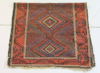 A red ground Afghan carpet with diamond design to the centre within multi-row border 82" x 38", some wear