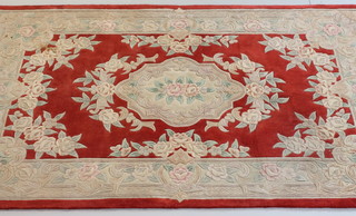 A red ground and floral patterned Chinese rug 97" x 61"