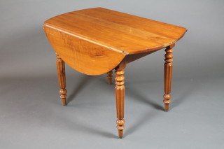 A 19th Century French fruit wood Pembroke table, having drop  leaf top, raised on turned and reeded tapered legs 27"h x 40"w x  43"d