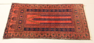 A red ground Belouche rug within multi row borders 55" x 32"