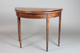 A George III mahogany demi-lune card table raised on square tapered supports 29"h x 36"w x 18"d