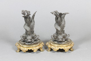 A pair of early 19th Century French bronze and ormolu stands, fashioned as 4 entwined dolphins on a Rococo style circular base  with scroll feet, 4.75"h