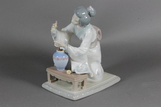 A Lladro seated Oriental lady