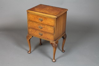 A Queen Anne style burr walnut bedside chest, walnut  crossbanded and fitted 3 long drawers, raised on shell carved cabriole legs and pad feet 26"h x 18"w x 13"d