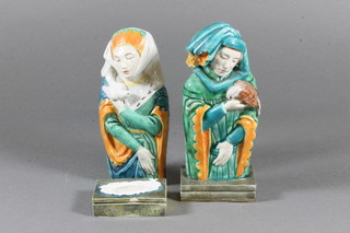 A pair of M Joyce Bidder faience figures of classical ladies with birds 6"