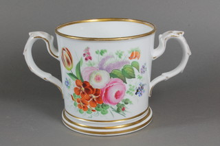A Victorian porcelain twin handled presentation loving cup with  floral decoration, marked James Newton Ashton, a present from  his friends 1856