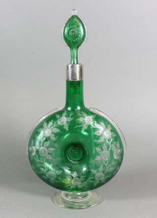 An etched green glass moon shaped decanter and stopper with  silver rim 13"