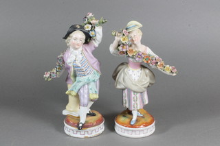A pair of 19th Century Dresden porcelain figures of bonnetted children with garlands of flowers, some chips to girl 7"