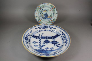 A 19th Century blue and white Delft dish decorated Chinese lanterns, chips to rim, and 1 other plate 9"