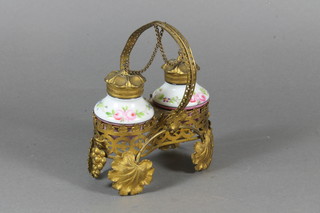A 19th Century French ormolu and porcelain 2 bottle condiment  raised on a pierced gilt metal stand