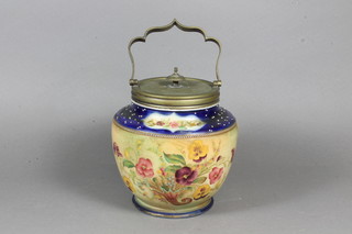 A circular Carltonware pottery biscuit barrel with floral  decoration and silver plated mounts 6"