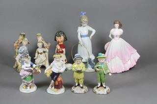 A pair of Continental porcelain figures of a boy and girl and 7 other figures