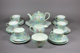 A 22 piece Shelley Melody pattern tea service comprising twin handled plate 10", 6 tea plates 6", 6 cups and 6 saucers, cream  jug, sugar bowl - cracked, base marked Shelley 13453