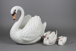 A Dartmouth white glazed pottery vase in the form of a swan 10"  and 2 smaller ditto