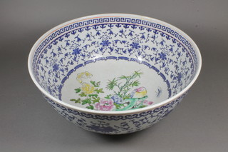 A Chinese bowl with blue and white floral decoration, the interior decorated birds 14"