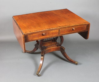 A late George III mahogany sofa table, rosewood crossbanded, fitted 2 opposing short drawers and 2 faux fronted drawers,  raised on lyre supports and quadripartite base, brass caps and  casters 29"h x 60"w x 27"d