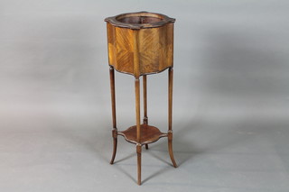 A circular mahogany jardiniere stand with undertier raised on turned supports