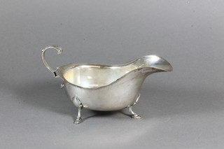 A silver Georgian style sauce boat with wavy border and C scroll handle, Chester 1908, 6 ozs