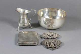 A circular silver bowl, London 1918, a silver cream jug Chester  1915, a silver cigarette case and a silver buckle - f, 9 ozs