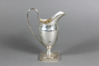 A Georgian style silver helmet shaped cream jug with bead work decoration and square base, Chester 1910, 4 ozs