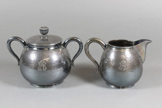 A Chinese planished white metal twin handled sugar bowl and  cream jug