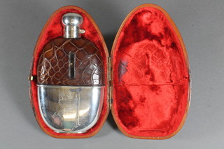 An Edwardian glass hip flask with silver plated mounts by  Mappin & Webb contained in a plush leather case  ILLUSTRATED