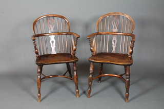 A near matching pair of early 19th Century Thames Valley high  back chairs, shaped and pierced splats, spindle backs above elm  saddle seats, raised on turned legs united by crinoline stretchers   ILLUSTRATED