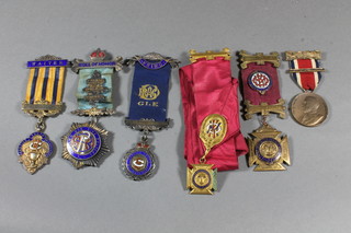 3 silver gilt and enamelled buffalo jewels, 2 silver plated do. and  a School attendance medal