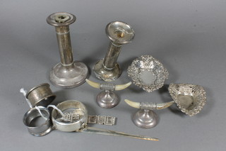 2 silver candle sticks - f, 5", 2 pierced silver dishes on bun feet,  a pair of horn and silver mounted knife rests, silver plated paper  knife etc