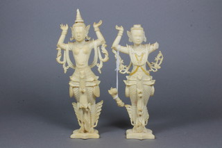 A pair of Balinese carved ivory figures of standing deities 7" - 1 f,