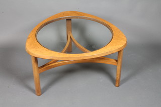 A 1960's Danish style teak coffee table of trefoil form with glazed top raised on shaped legs united by bowed stretchers  17.5"h x 31"w