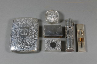 A Victorian cylindrical pierced silver scent phial London 1898, a hinged silver match box Birmingham 1927, a silver match slip,  cylindrical silver box and a silver cigar cutter and an Edwardian  engraved silver cigarette case with crest