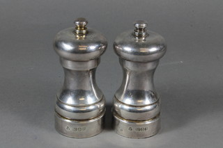 A pair of modern waisted silver salt and pepper mills