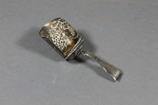 A Georgian silver fiddle pattern caddy spoon, the bowl embossed  grapes by Lea & Clark, Birmingham marks rubbed