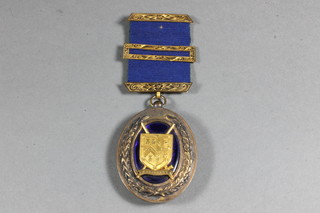 A 15ct gold Masonic Grand Officer's collar jewel Assistant  Grand Pursuivant approx 37.3 grams together with a blue ribbon  with 9ct gold mount, approx 6.8 grams