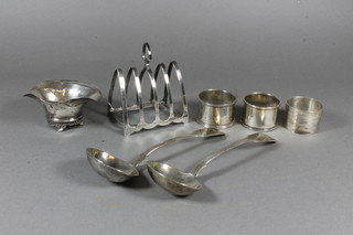 A pair of Victorian silver fiddle pattern sauce ladles London 1840, a silver 5 bar toast rack, 3 silver napkin rings and an oval  salt, 8 ozs
