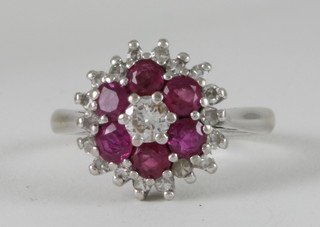 An 18ct white gold cluster ring set rubies and diamonds