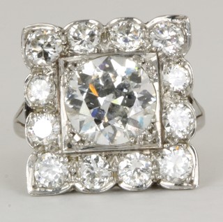 An impressive 18ct gold dress ring set a square cut diamond  surrounded by diamonds, the central stone approx 2.75ct, in total  approx 4.75ct  ILLUSTRATED
