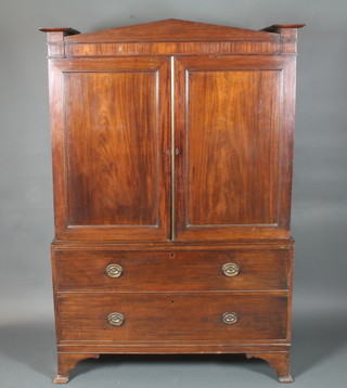 A Victorian mahogany linen press the interior fitted 4 shelves enclosed by panelled doors, the base fitted 2 long drawers,  raised on ogee bracket feet 73"h x 49"w x 23"d