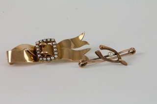 A 9ct gold ribbon shaped brooch set pearls and a 9ct gold wish  bone bar brooch