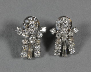 A pair of white gold and diamond earrings set rows of circular  cut and baguette diamonds