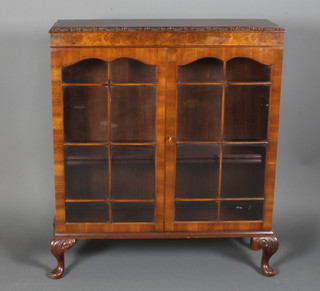 A Queen Anne style figured walnut display cabinet with crossbanded top the interior fitted adjustable shelves enclosed by  astragal glazed doors, raised on cabriole supports 41"h x 36"w x  11.5"d