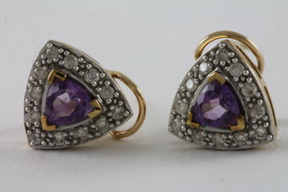 A pair of 9ct gold earrings set amethysts and diamonds